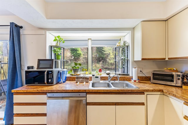 kitchen featuring sink, stainless steel appliances, and a textured ceiling