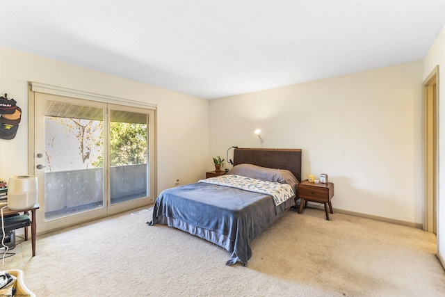 carpeted bedroom with access to exterior