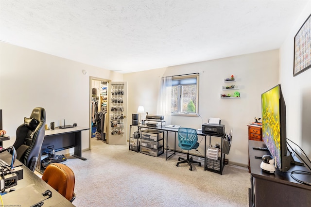 carpeted home office featuring a textured ceiling