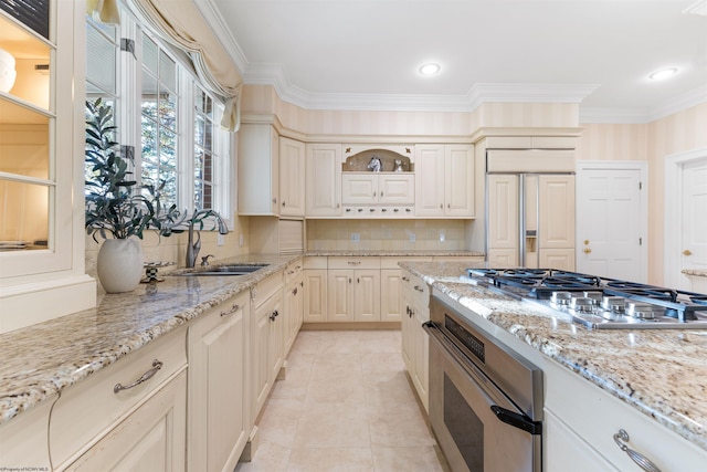 kitchen featuring appliances with stainless steel finishes, tasteful backsplash, light stone counters, crown molding, and sink