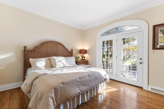 bedroom featuring wood-type flooring, access to outside, a baseboard radiator, and ornamental molding