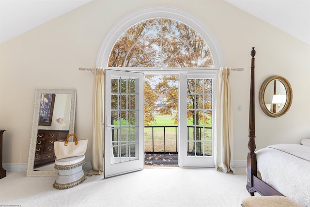 carpeted bedroom with access to outside, multiple windows, and lofted ceiling