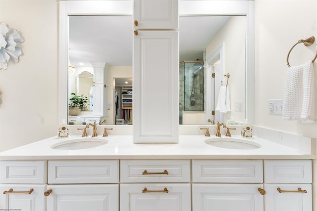 bathroom featuring vanity and a shower with shower door