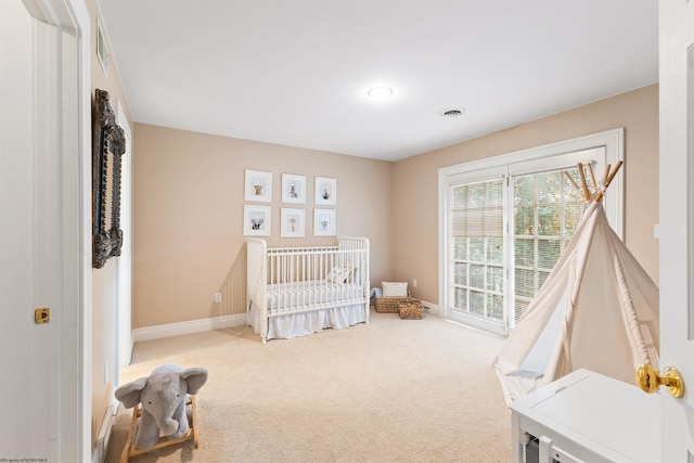 bedroom with carpet flooring and a crib