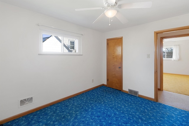 unfurnished bedroom featuring ceiling fan and dark colored carpet