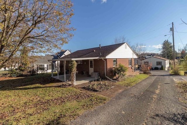 rear view of property featuring a yard and a patio