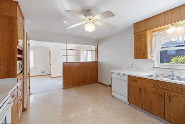 kitchen featuring white appliances, sink, and ceiling fan