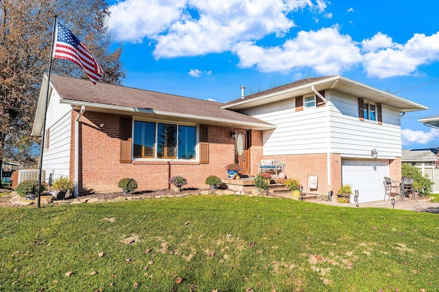 tri-level home with a garage and a front lawn