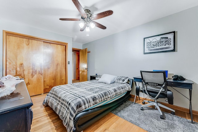 bedroom featuring a closet, light hardwood / wood-style flooring, and ceiling fan