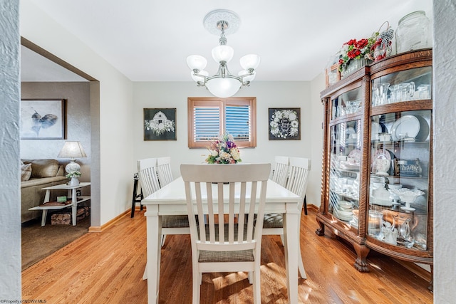 dining room with a chandelier and light hardwood / wood-style floors