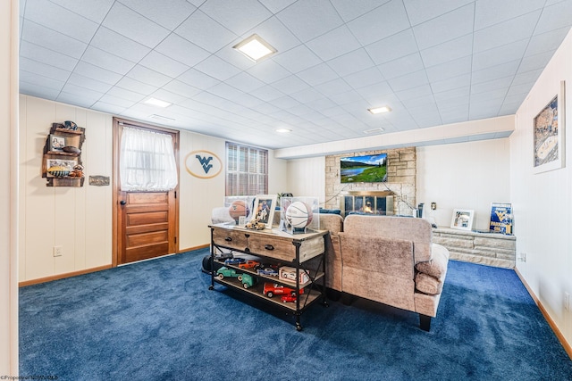 living room with a fireplace and dark carpet