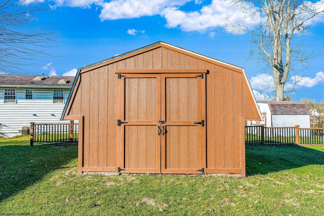 view of outbuilding featuring a lawn