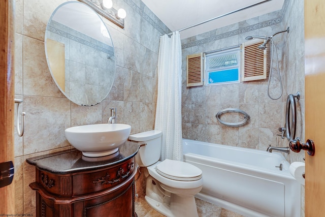 full bathroom with shower / bath combination with curtain, vanity, tile walls, tile patterned flooring, and toilet