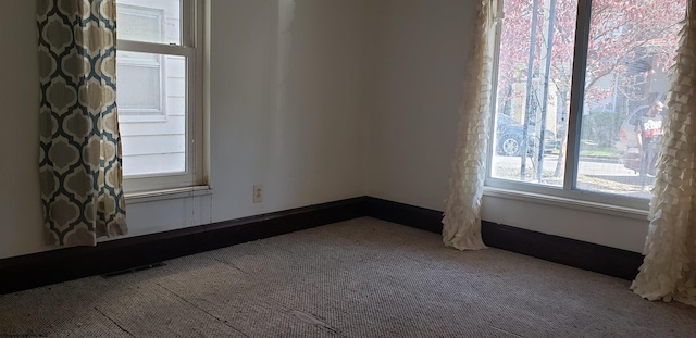 unfurnished room featuring carpet flooring