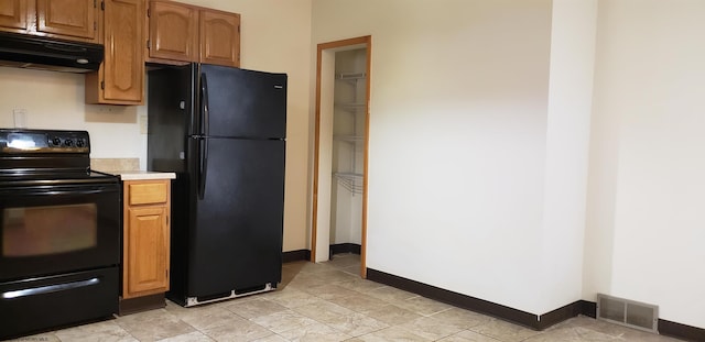 kitchen featuring extractor fan and black appliances