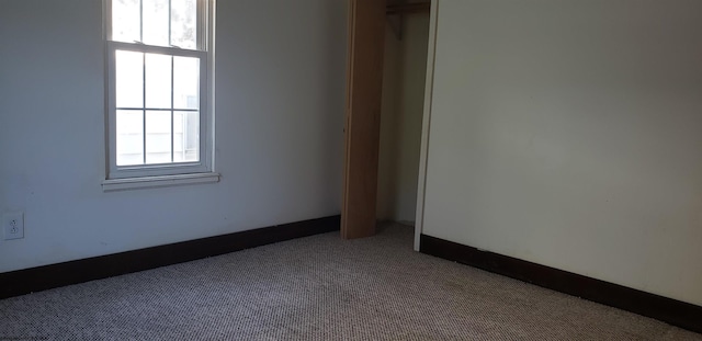 carpeted empty room featuring plenty of natural light