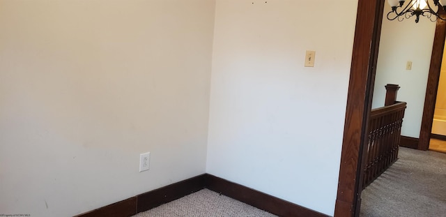 interior space with carpet floors and a chandelier