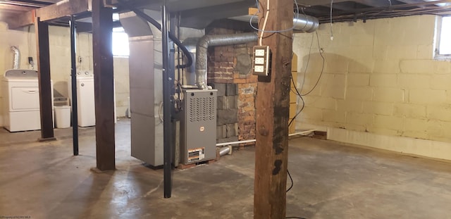 basement featuring heating unit and washing machine and dryer