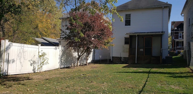 back of house with a lawn