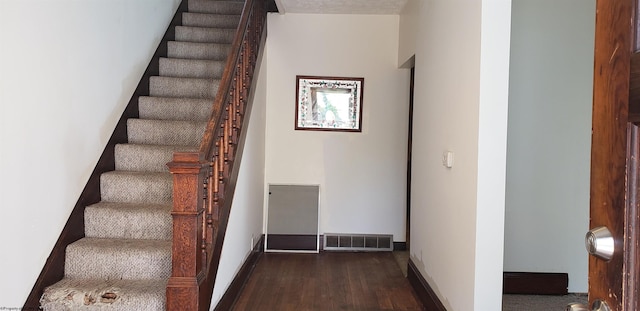 staircase featuring hardwood / wood-style floors