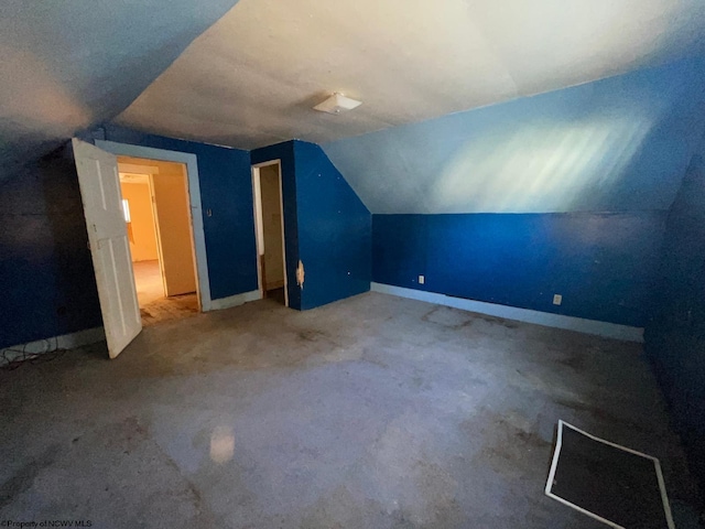 additional living space with carpet floors and lofted ceiling