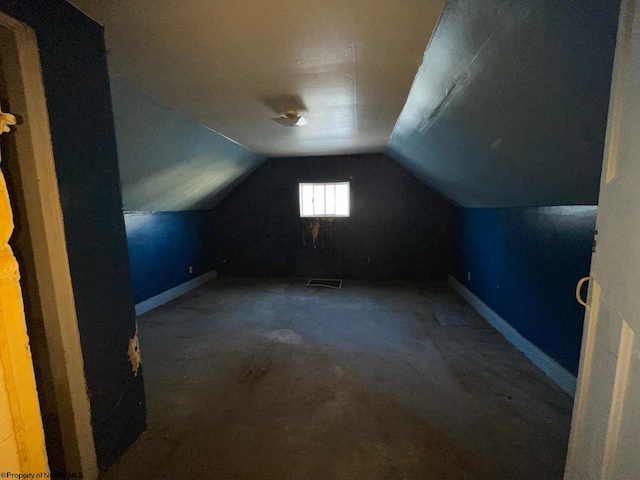 bonus room featuring carpet floors and vaulted ceiling