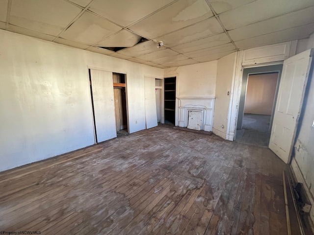 unfurnished bedroom featuring hardwood / wood-style flooring and a paneled ceiling