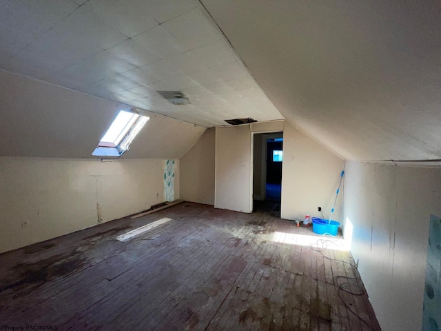 bonus room featuring wood-type flooring and vaulted ceiling with skylight