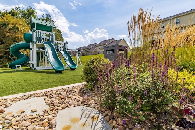 view of playground with a lawn