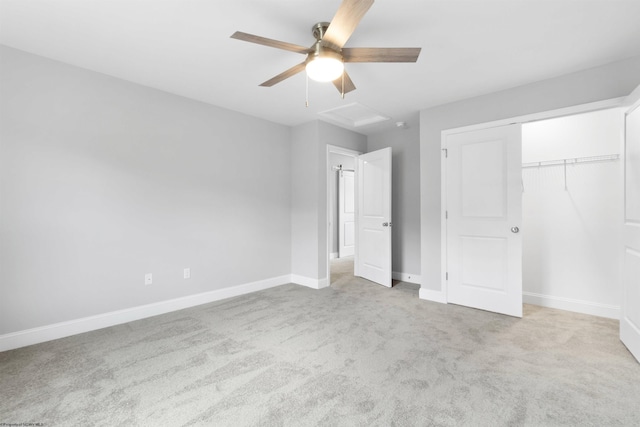 unfurnished bedroom with ceiling fan, light colored carpet, and a closet