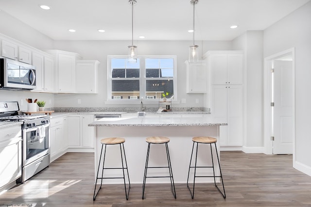 kitchen featuring white cabinetry, a center island, and appliances with stainless steel finishes