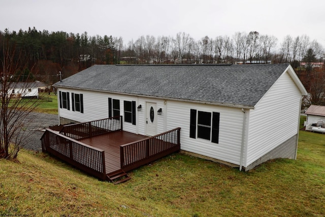 back of property with a lawn and a wooden deck