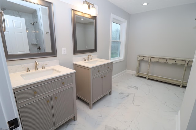 bathroom featuring tiled shower and vanity