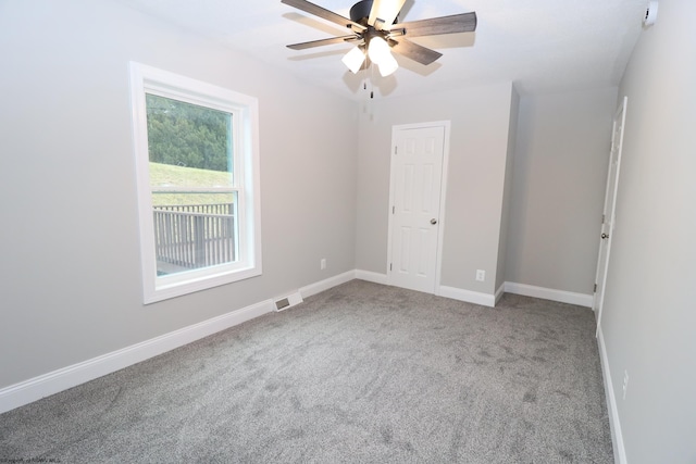 spare room with carpet and ceiling fan