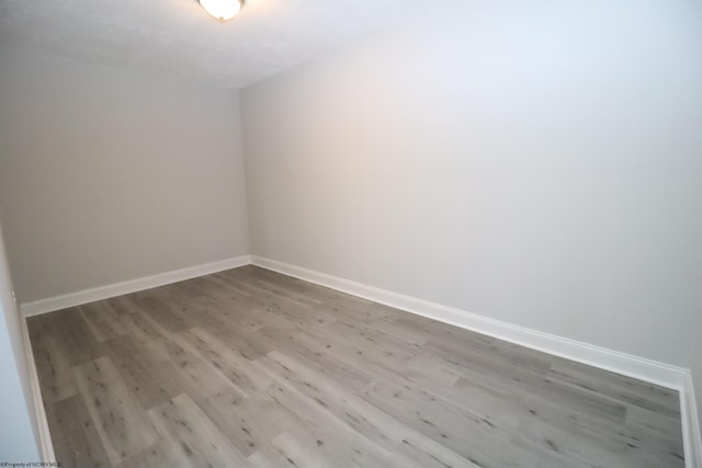 unfurnished room featuring hardwood / wood-style flooring