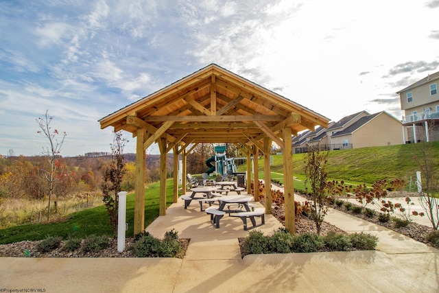 view of community featuring a playground and a yard