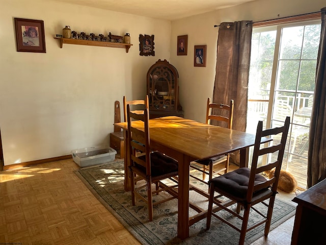 dining area featuring parquet flooring