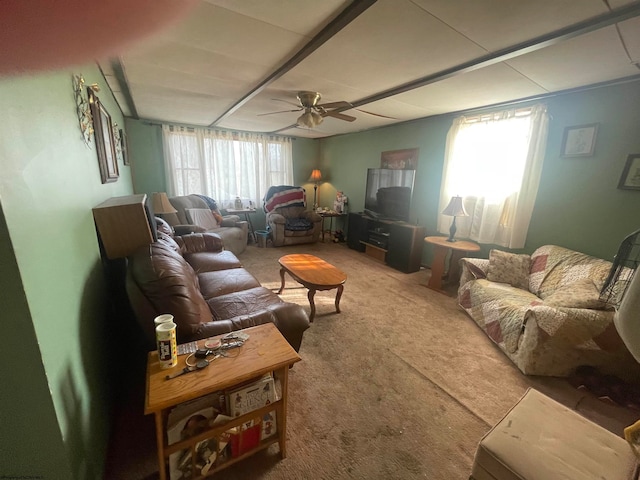 living room featuring ceiling fan, carpet, and a healthy amount of sunlight