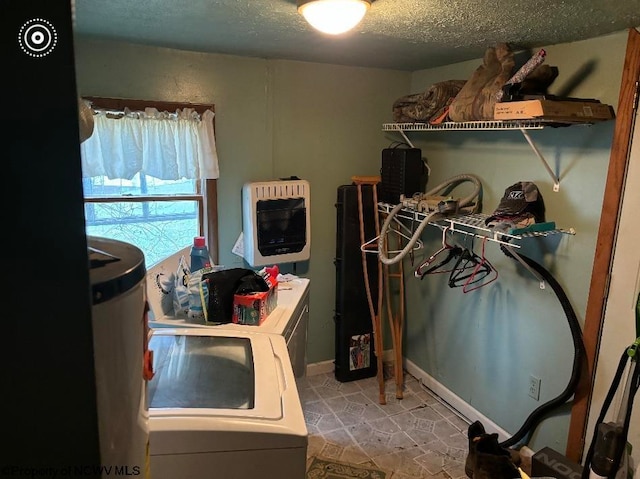 laundry area featuring independent washer and dryer, a textured ceiling, light tile patterned floors, and heating unit