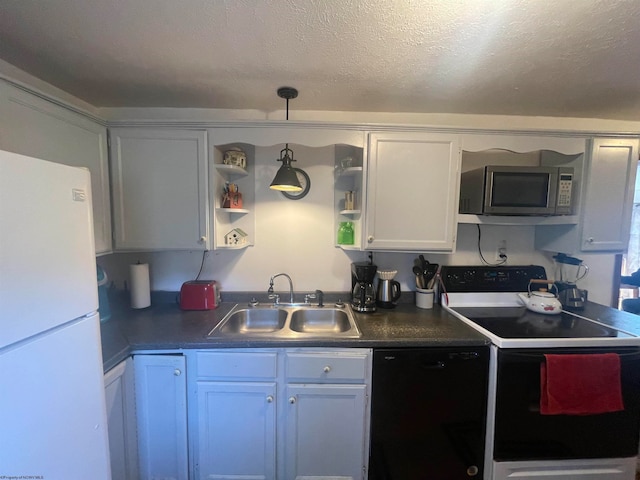 kitchen with pendant lighting, white appliances, white cabinets, sink, and a textured ceiling