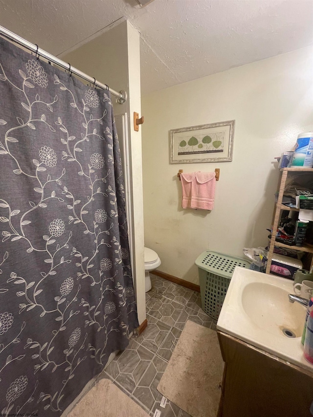 bathroom with tile patterned flooring, vanity, curtained shower, and toilet