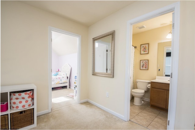 bathroom featuring tile patterned flooring, vanity, and toilet