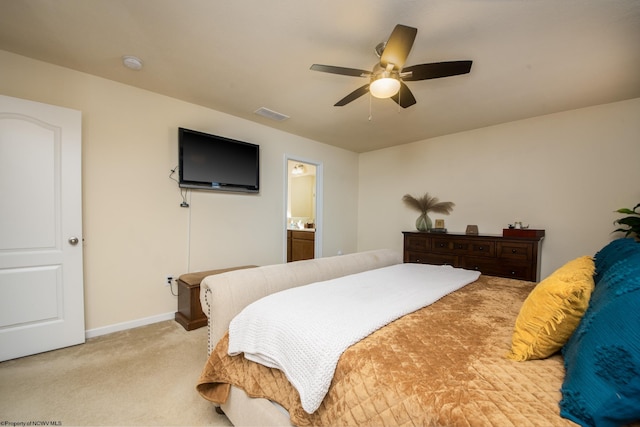 bedroom featuring ensuite bathroom, ceiling fan, and light colored carpet