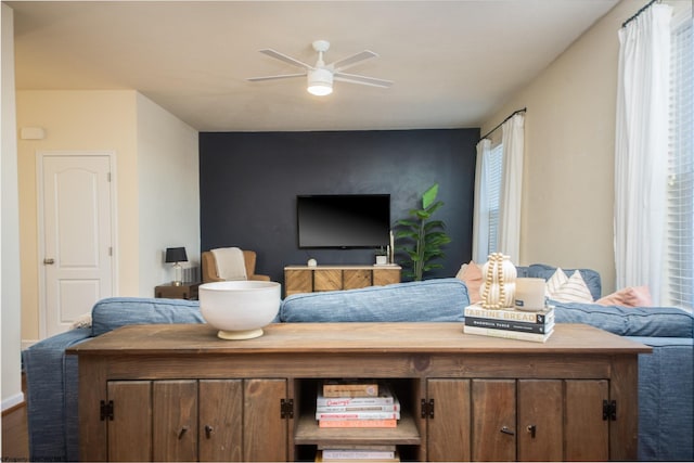 living room with ceiling fan and hardwood / wood-style flooring