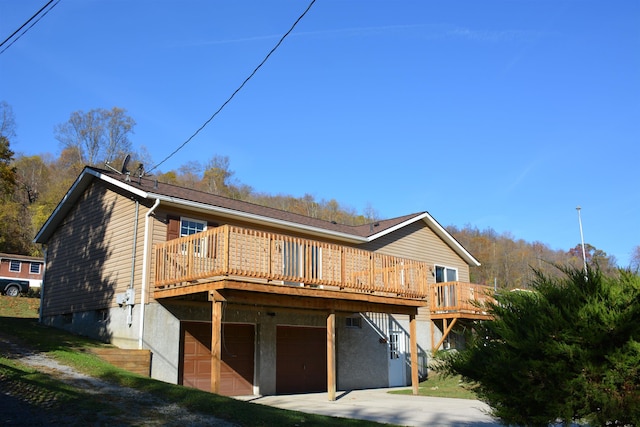 exterior space featuring a garage and a wooden deck