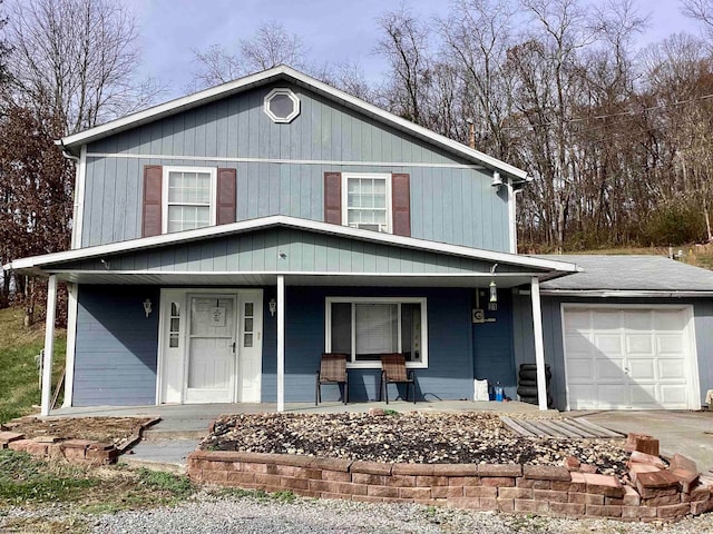 view of property featuring a porch and a garage