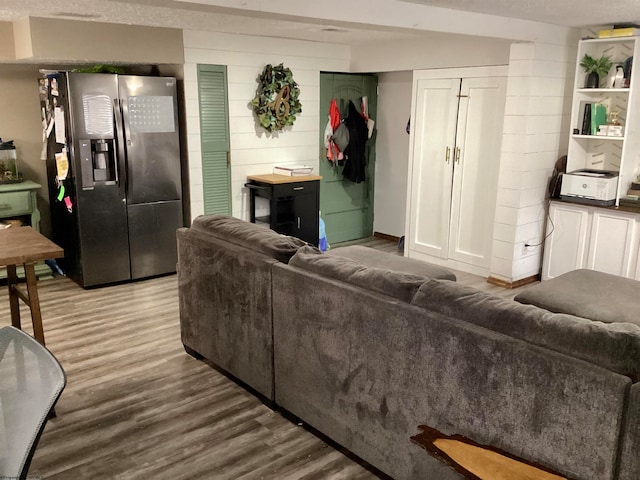 living room featuring a textured ceiling and hardwood / wood-style flooring