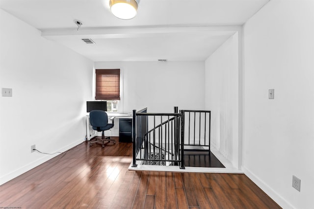 interior space featuring beamed ceiling and dark hardwood / wood-style floors