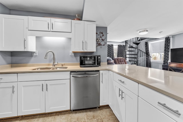 kitchen with white cabinets, dishwasher, kitchen peninsula, and sink