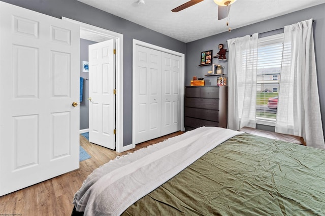 bedroom featuring a closet, ceiling fan, hardwood / wood-style floors, and a textured ceiling